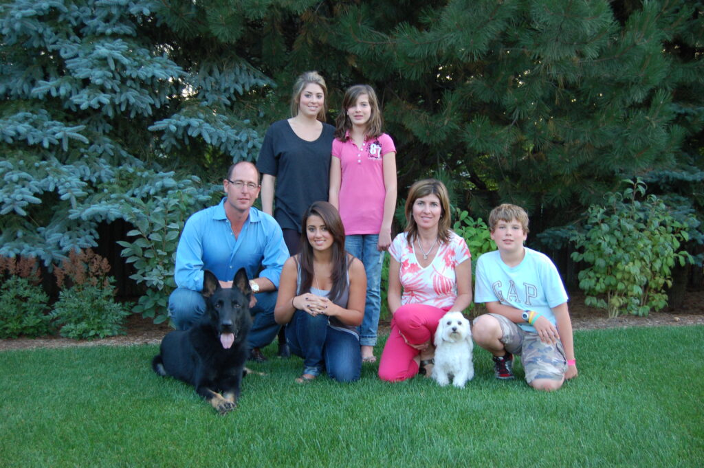 Family sitting on their lawn with their new Protection Dogs